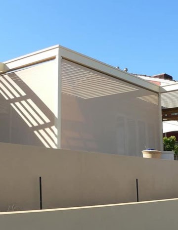 Showing Ziptrak awnings as an exterior blind system for a modern home patio