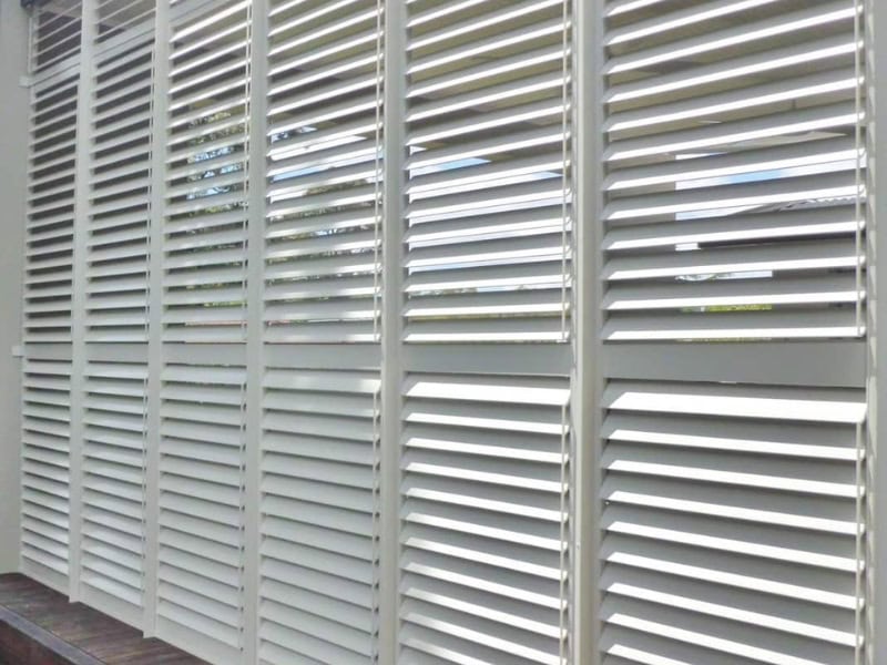 White aluminium exterior shutters on windows providing shade and privacy in a modern Australian home