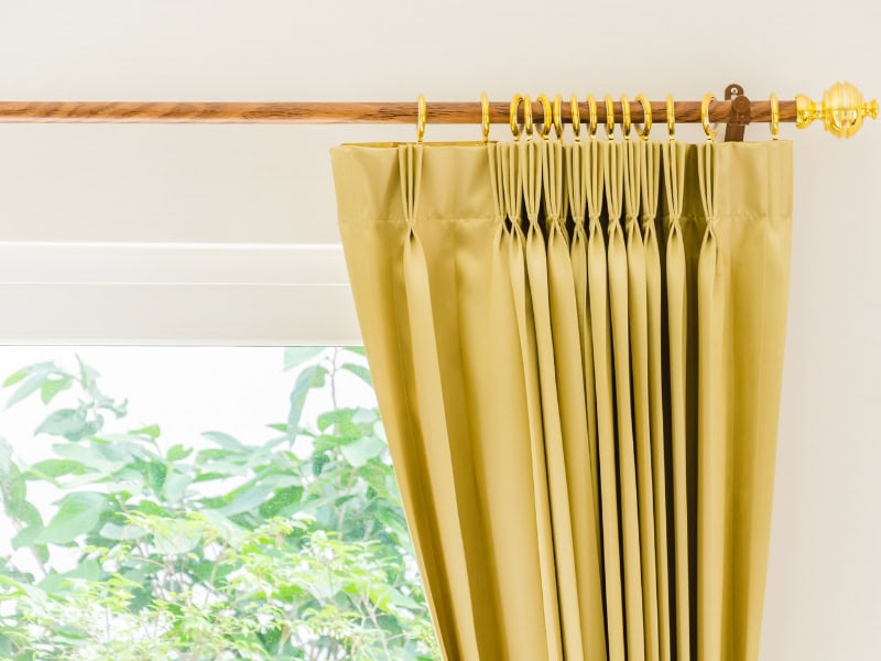 Comparing curtains to installing interior window shutters for better light control and energy efficiency.